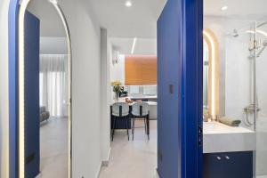 a bathroom with a blue door and a kitchen at FatCow Suites City Centre in Larnaca +82 photos