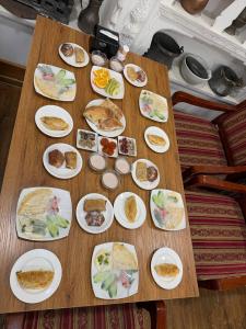 a wooden table with plates of food on it at SHoxtut INN 18-19Th Century in Bukhara