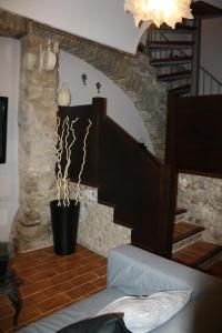 a living room with a staircase and a stair case at Cal Arxè in Besalú