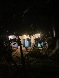 a white building with windows at night at Phoenix Crest Cottage in Haputale