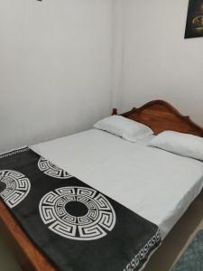 a bedroom with a bed with a blanket on it at Phoenix Crest Cottage in Haputale