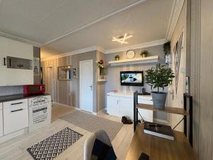 a kitchen with white cabinets and a table with a plant at Bellevue in Colmar