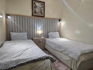 two beds in a small room with at Appartement familial شقة للعائلة in Meknès