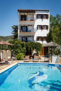 a hotel with a swimming pool in front of a building at Seranides Boutique Hotel in Kato Gatzea