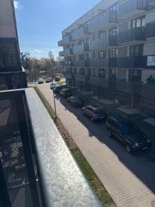 a view of a street with cars parked next to a building at Amazing Studio Close to Oldtown in Gdańsk
