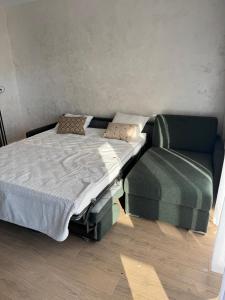 a bed and a chair in a room at Amazing Studio Close to Oldtown in Gdańsk