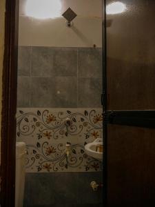 a bathroom with a toilet and a sink in a room at Hotel GK Lodging & Boarding in Khāpri +6 photos