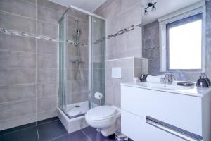 a bathroom with a shower and a toilet and a sink at Gorgeous duplex near top attractions in Saint-Ouen +21 photos