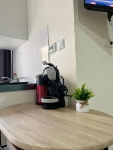 a kitchen counter with a coffee maker on a table at Love appart Parisienne in Villeneuve-Saint-Georges