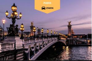 a bridge over a river in a city at night at Love appart Parisienne in Villeneuve-Saint-Georges
