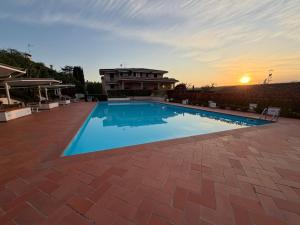 a large swimming pool in front of a house at Residence agli Oleandri in Manerba del Garda