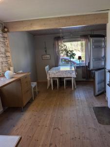 a kitchen with a table and a dining room at Steneryd Salongen in Karlskrona