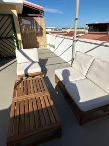 two chairs and a couch on the deck of a boat at Dune House in Ginosa Marina