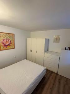 a small bedroom with a bed and a refrigerator at Počitniška hiša Eva in Velike Lašče