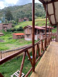 a wooden bridge with a view of a village at Raíz Azul in Pisac
