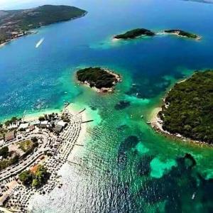 an aerial view of a group of islands in the water at Meta apartment in Ksamil +5 photos