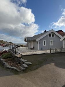 a large house with a dock next to the water at Nordic Elegance Retreat in Sørvågen