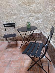 a table and a chair with a cup on it at Casetta d'Ossuna in Palermo