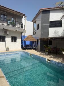 a swimming pool in front of a house at Keur Medzo - Lac Rose in Niaga +47 photos