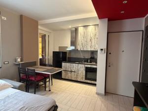 a room with a kitchen and a table and a bed at Al Piano 2 in Ancona