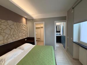 a bedroom with a bed and a stone wall at Al Piano 2 in Ancona
