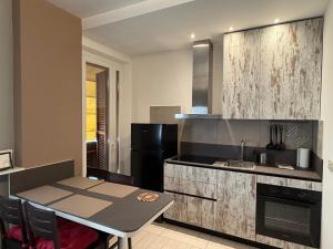a kitchen with a table and a stove and a sink at Al Piano 2 in Ancona +5 photos