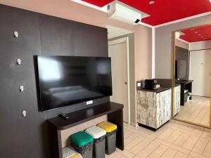 a room with a large flat screen tv on a wall at Al Piano 2 in Ancona