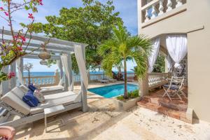 a villa on the beach with a swimming pool at Tres Sirenas Beach Inn in Rincon +93 photos