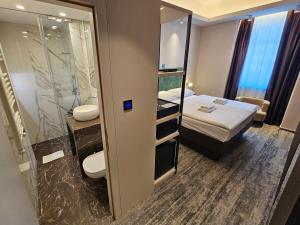 a small room with a bed and a bathroom at Hotel Center Ljubljana in Ljubljana +51 photos