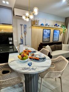a living room with a table with food on it at Safira Azul Luxury Flat Carneiros in Tamandaré +51 photos