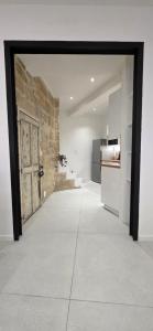 a large room with a door and a kitchen at Casa Loulou in Saint-Laurent-dʼAigouze