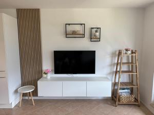 a living room with a flat screen tv on a wall at Apartment Planika Bovec in Bovec