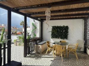 a patio with a table and chairs on a balcony at Swallows Nest in Quarteira