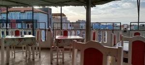 a balcony with tables and chairs on a building at Residencial Monte Sintinha in Espargos