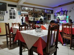 a dining room with a table with red and white table cloth at Residencial Monte Sintinha in Espargos