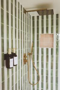 a bathroom with green and white tiled walls at Le Chalet du Michel in Hardifort +61 photos