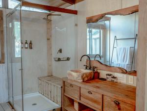 a bathroom with a tub and a sink and a shower at Premium Lakefront Cabin 1 The Armadillo in Bastrop