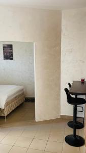 a room with a bed and a table and a chair at Panorama - 2 Lazarevac in Lazarevac +4 photos