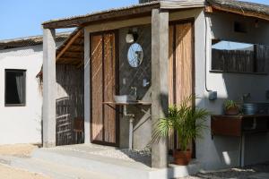a front door of a house with a clock on it at Ohana cerritos in El Pescadero