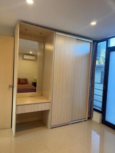 a bedroom with a closet with a bed in it at Trendy Edge Apartments in Nadi