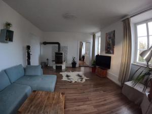 a living room with a couch and a dog laying on the floor at Ferienwohnung Altes Pfarrhaus in Blumberg