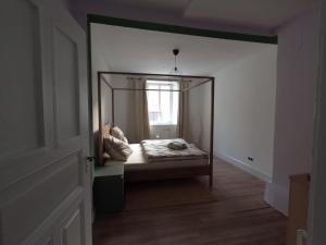 a small bedroom with a bed in a mirror at Ferienwohnung Altes Pfarrhaus in Blumberg