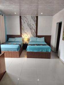 a bedroom with two beds and a painting on the wall at Casa las Flores in Puerto Vallarta +37 photos