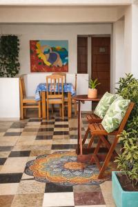 a living room with a table and chairs and a floor at Suites Quebra Mar in Rio de Janeiro