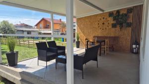 a patio with a table and chairs on it at Kuća za odmor Sofija in Beli Manastir