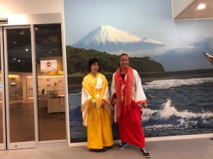 two women are standing in front of a mountain at MtFuji Homestay Leoya in Fuji