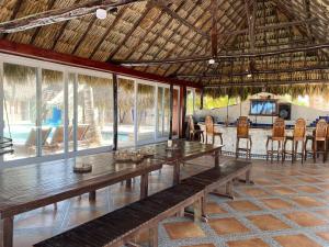 a dining room with a wooden table and chairs at Jaguar Club & Casitas in Santa Clara