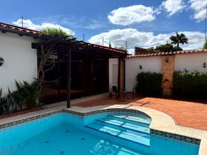 a swimming pool in front of a house at Casa KOMU in Asunción