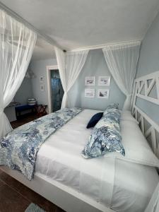 a white bed with pillows on it in a bedroom at Jaguar Club & Casitas in Santa Clara
