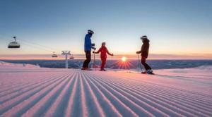 a group of people standing on top of a ski slope at Trysil sentrum apartment in Trysil